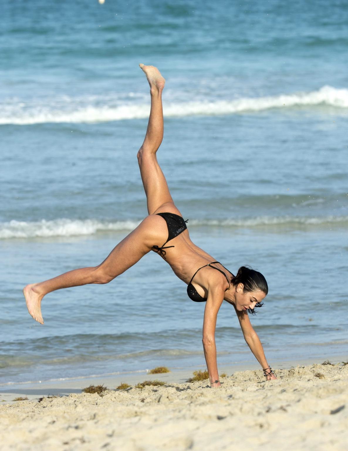 16P Federica Torti in black bikini doing yoga on a beach in Miami