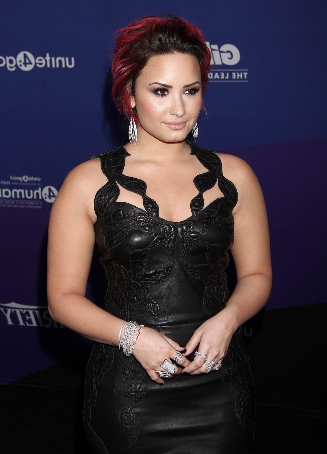 16P Demi Lovato wearing tight black leather mini dress at 2014 unite4:humanity Gala 