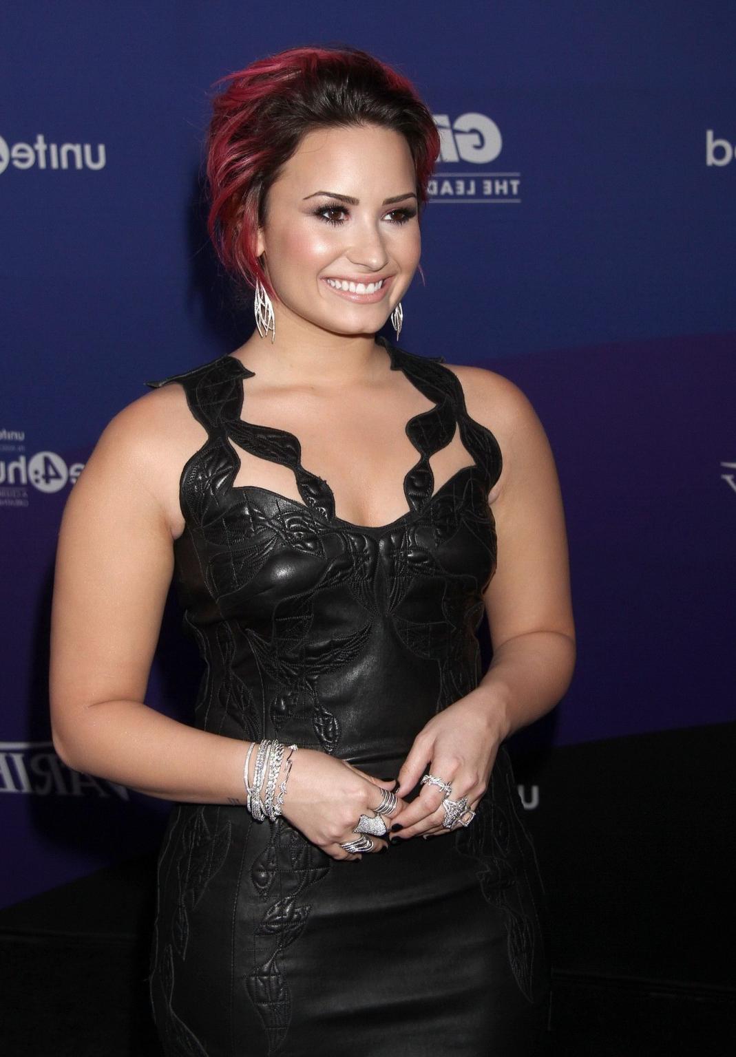 16P Demi Lovato wearing tight black leather mini dress at 2014 unite4:humanity Gala 