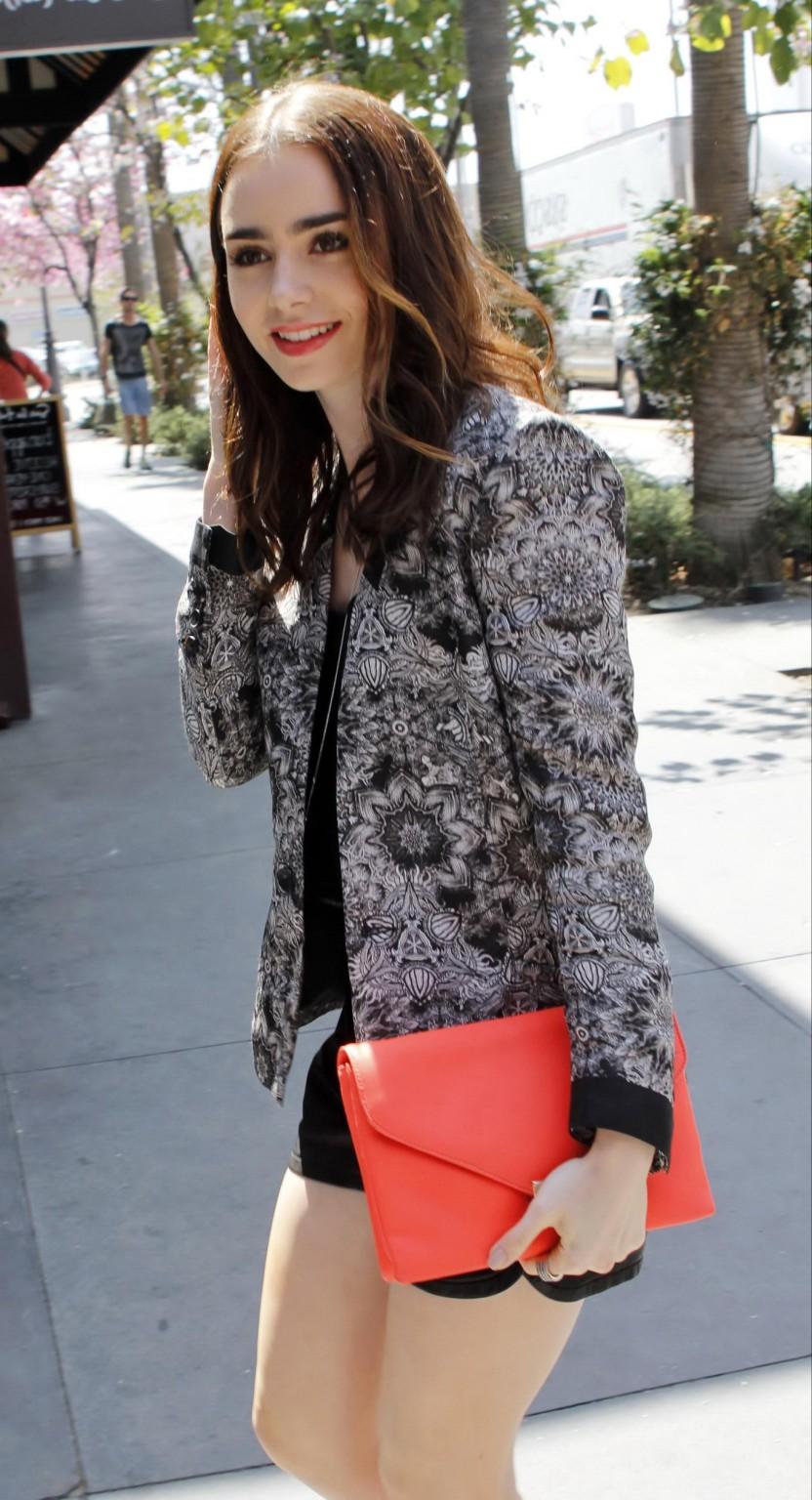 16P Lily Collins leggy wearing a leather shorts on the set of Extra in LA
