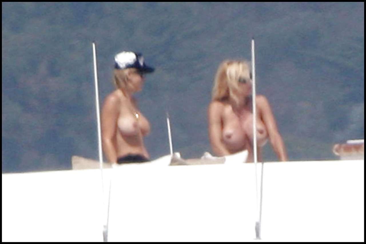 16P Pamela Anderson posing in stockings and showing her big boobs on yacht