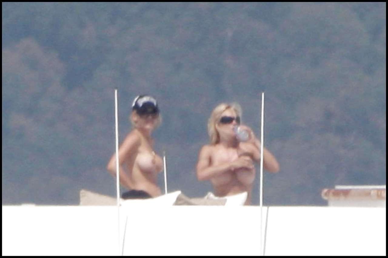 16P Pamela Anderson posing in stockings and showing her big boobs on yacht