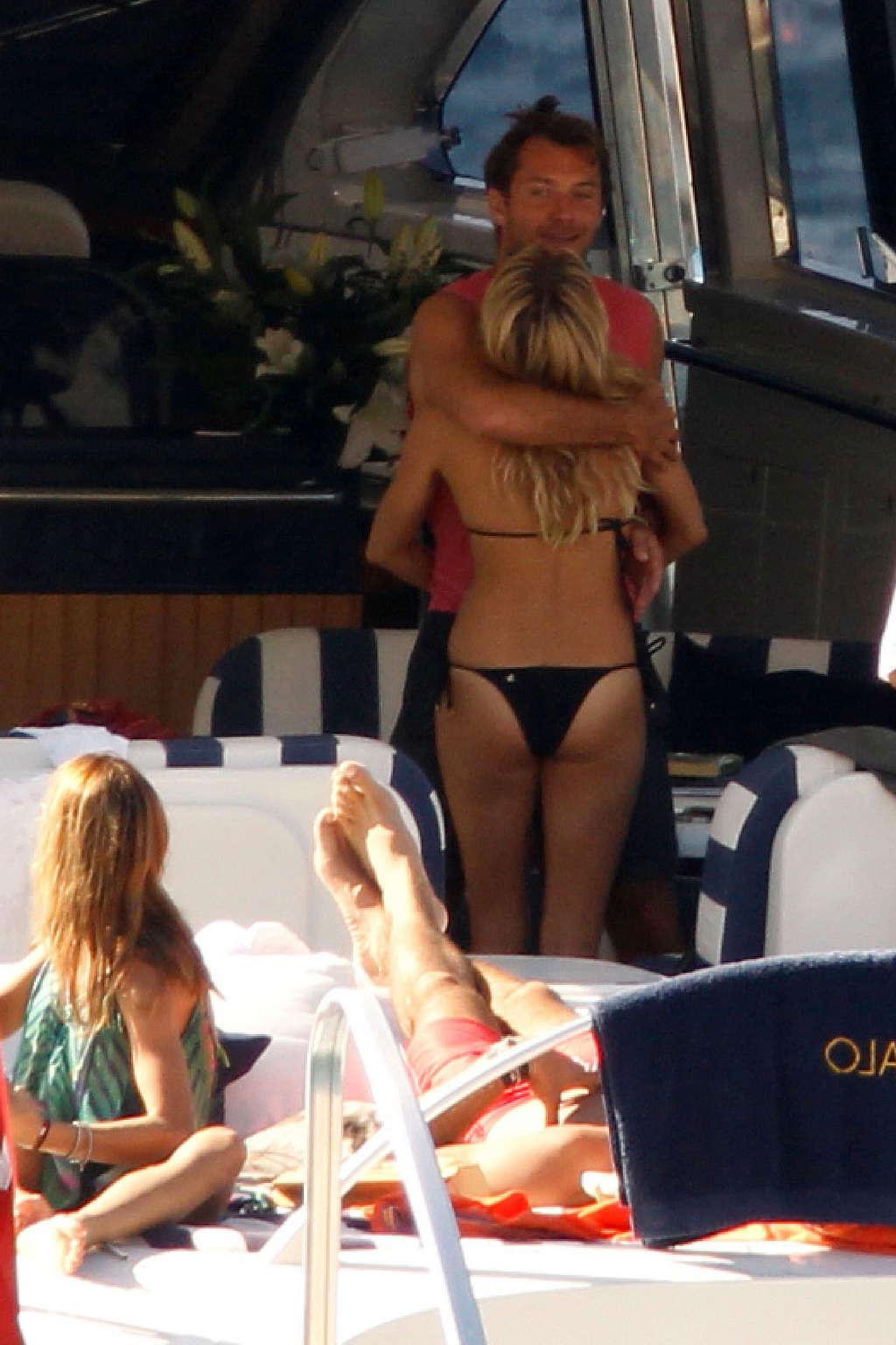 16P Sienna Miller exposing her sexy body and hot ass in black bikini on yacht