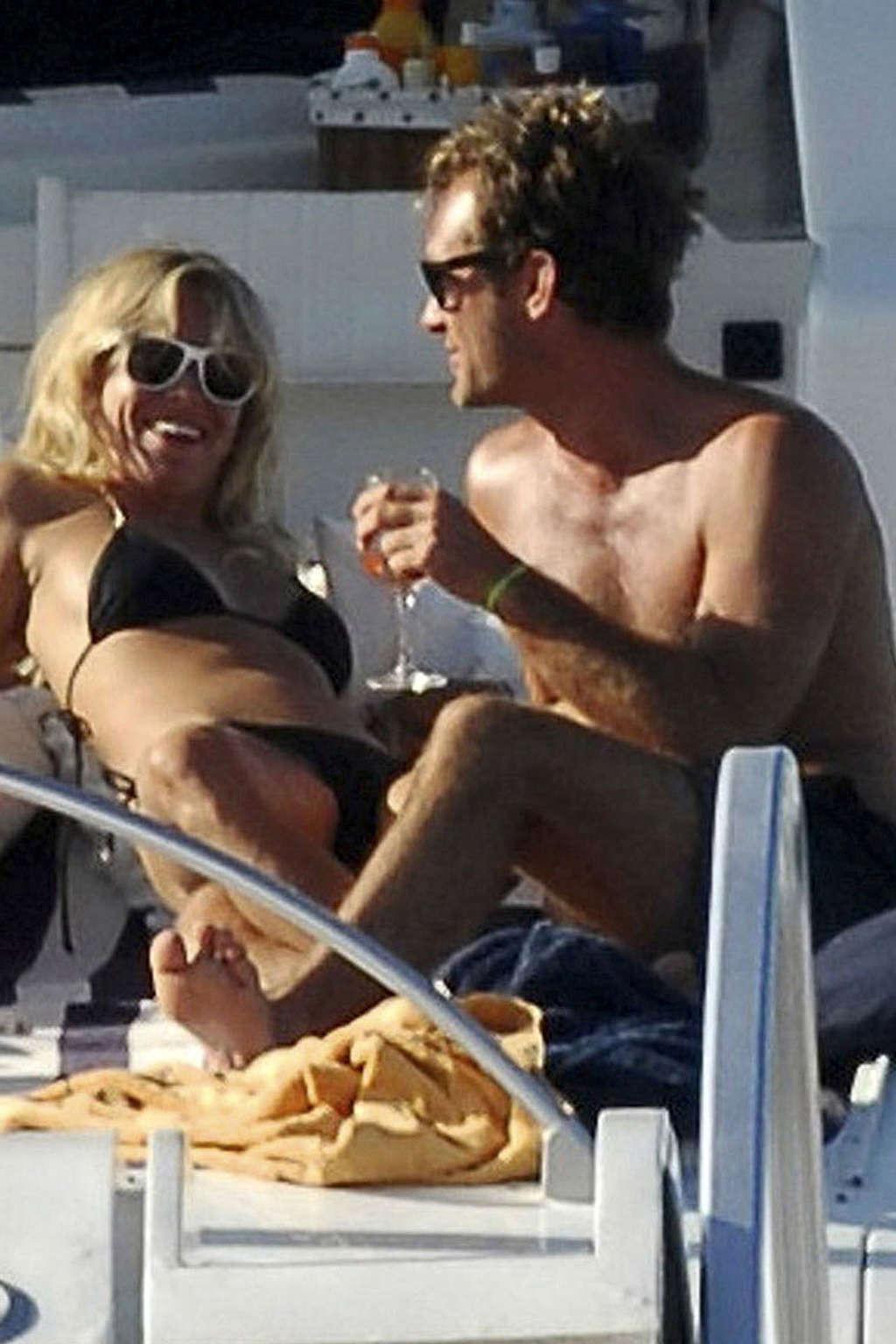 16P Sienna Miller exposing her sexy body and hot ass in black bikini on yacht