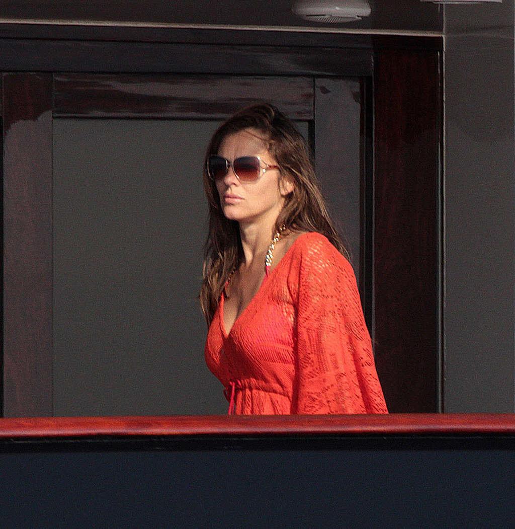 16P Elizabeth Hurley exposing her sexy body and huge boobs in bikini on yacht