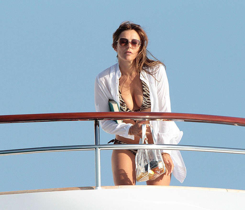16P Elizabeth Hurley exposing her sexy body and huge boobs in bikini on yacht