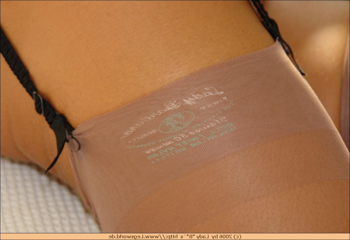 12P Leggy Lady B in tan stockings posing on bed