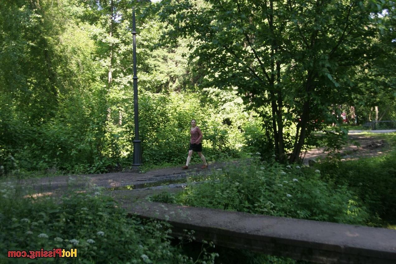15P Blushing chick in glasses does a great pee stream from the park bridge