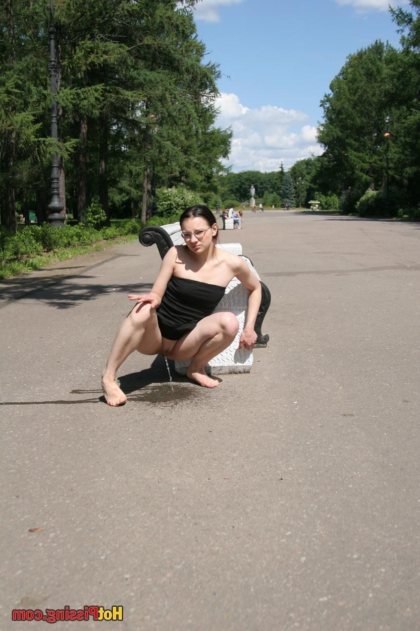 10P Hotsy with bare feet and in glasses makes a show of her peeing pussy