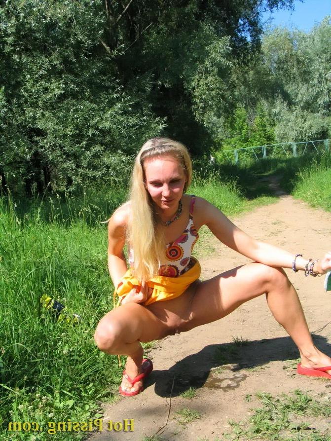 15P Blonde hottie with long hair takes pleasure in doing a pee on the road
