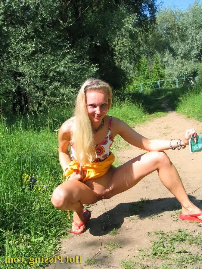15P Blonde hottie with long hair takes pleasure in doing a pee on the road