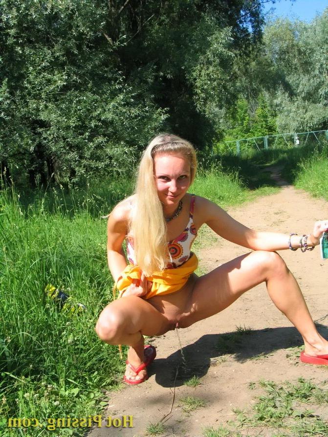 15P Blonde hottie with long hair takes pleasure in doing a pee on the road