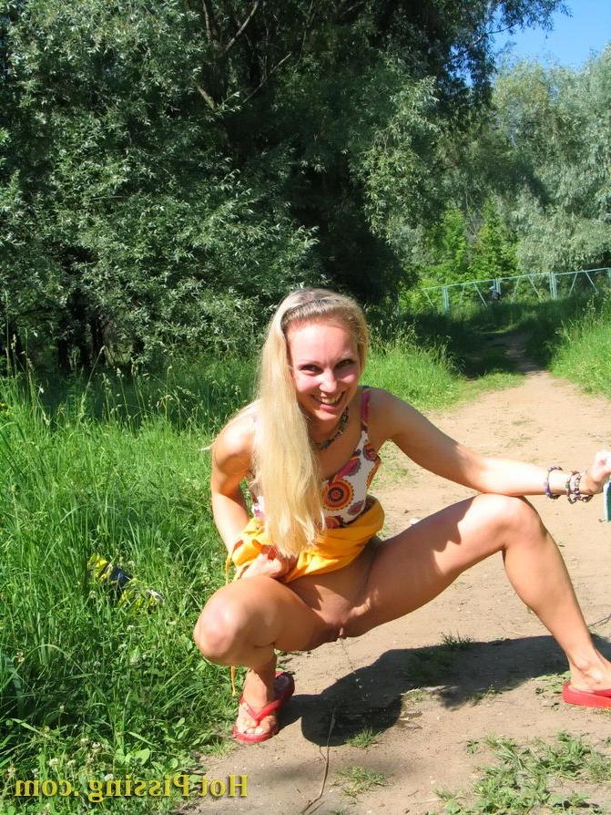 15P Blonde hottie with long hair takes pleasure in doing a pee on the road