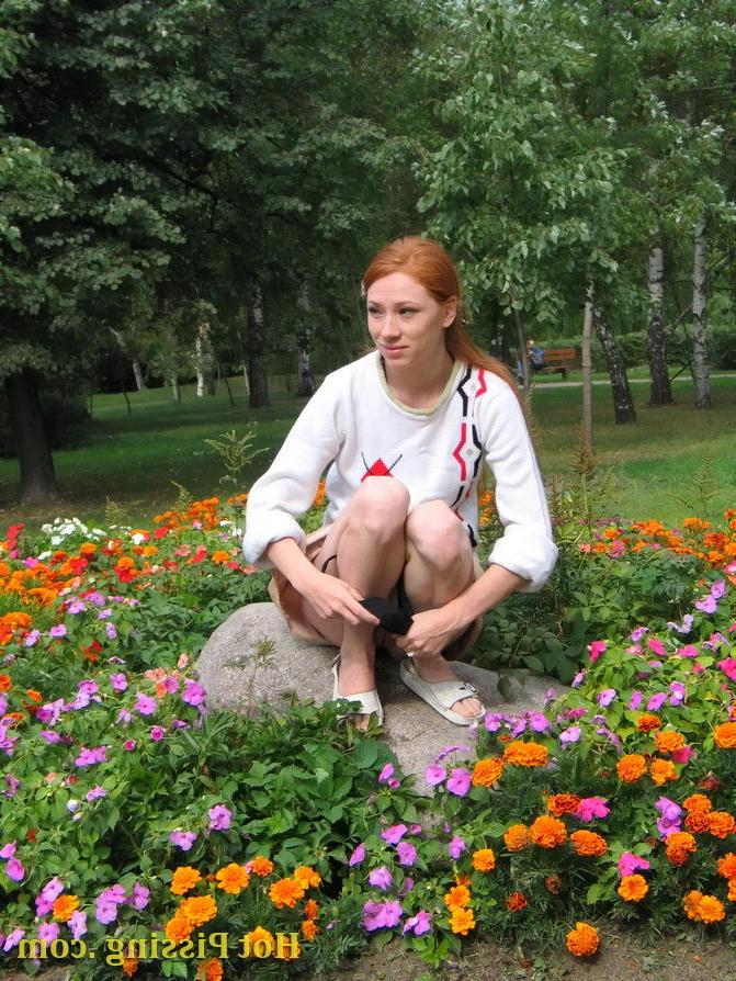15P Naughty wench squats in the middle of a flowerbed and makes a pee-pee