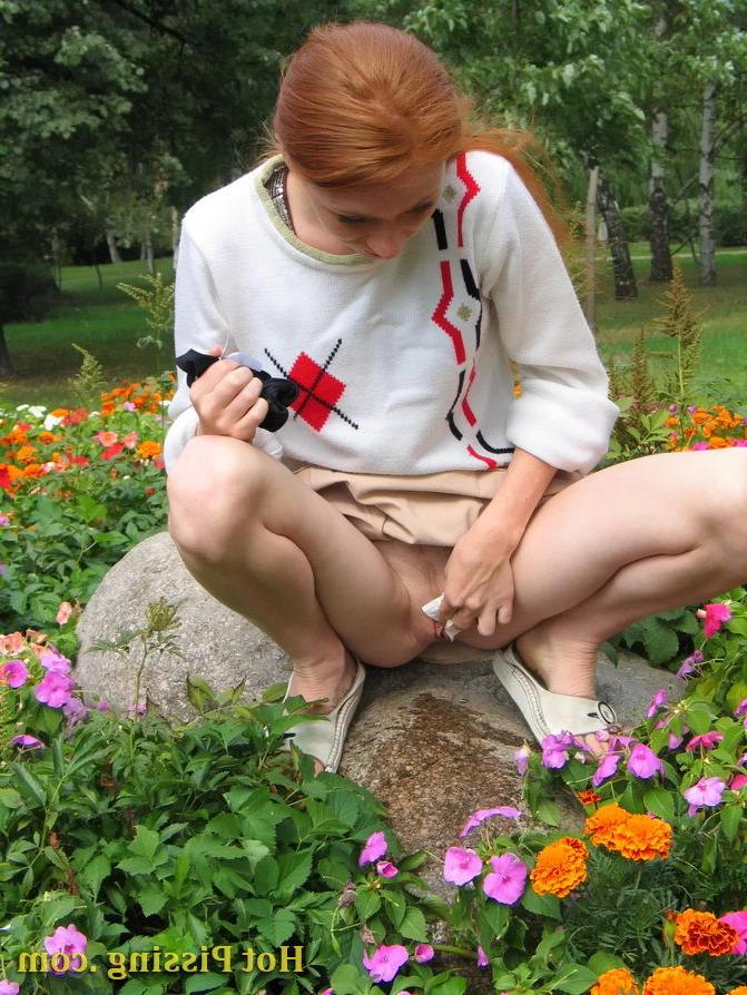 15P Naughty wench squats in the middle of a flowerbed and makes a pee-pee