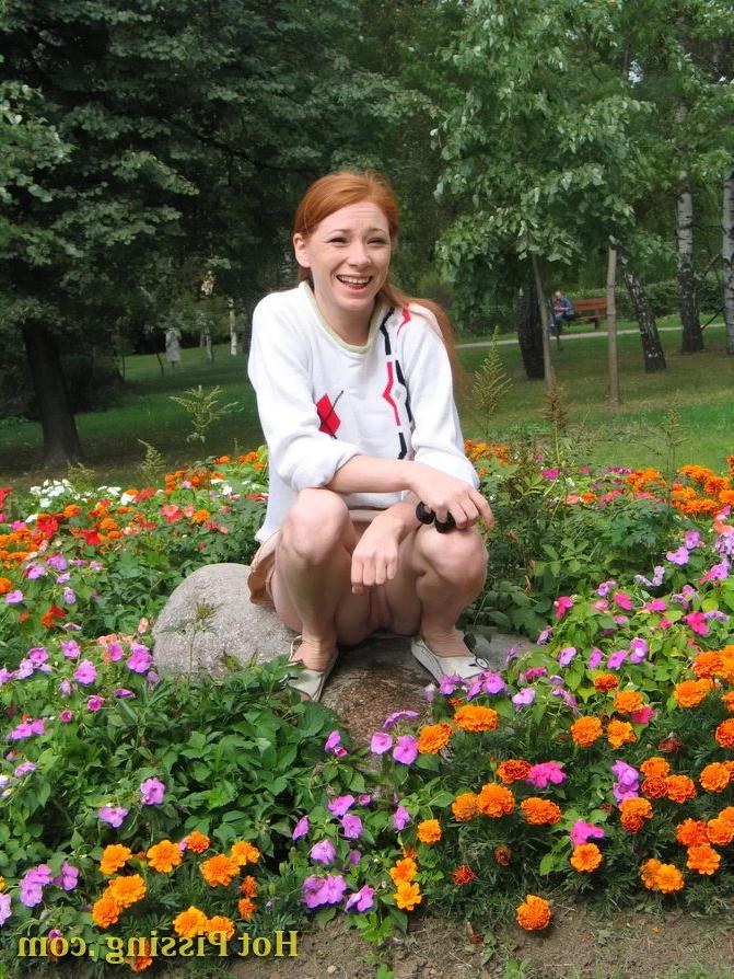 15P Naughty wench squats in the middle of a flowerbed and makes a pee-pee