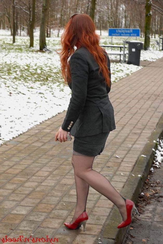 12P Redhead Justine with sexy stockinged legs in red high heels
