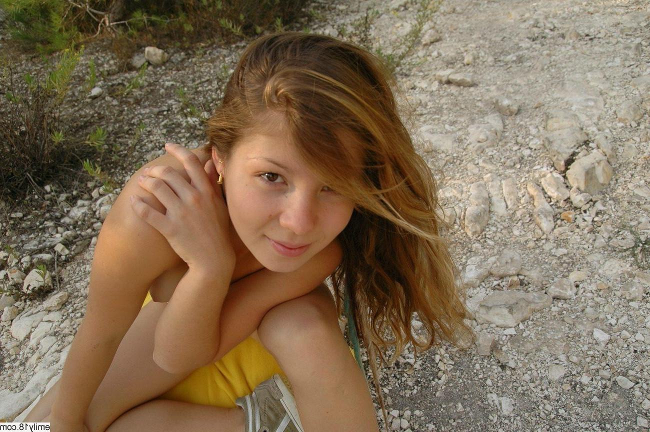 14P Young Emily showing her tits outside in the sand