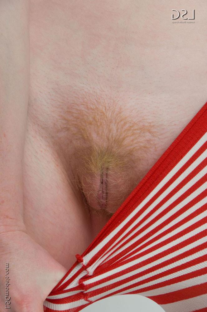 16P Redhead girl takes off striped pantyhose and shows her red bush