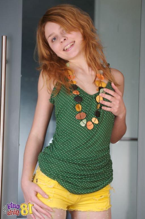 15P Young redhead taking off her pantyhose