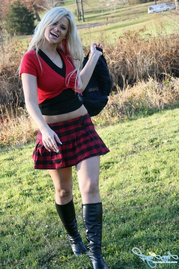 15P Busty Anna Angel in a tight red schoolgirl outfit outdoors