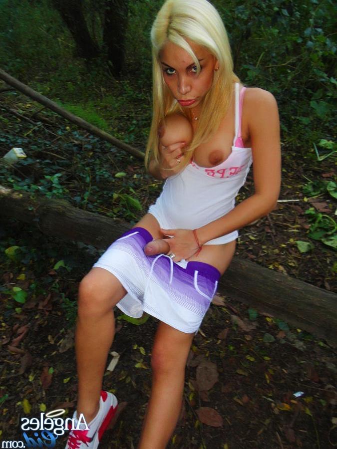 13P Sluttye and Very Hung Blonde Shemale Angeles Cid stroking her cock in the woods