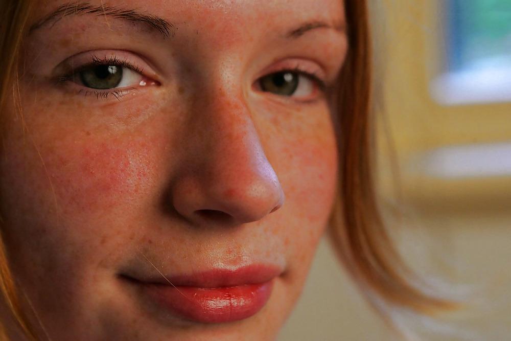 12P Lovely redhead on her bed