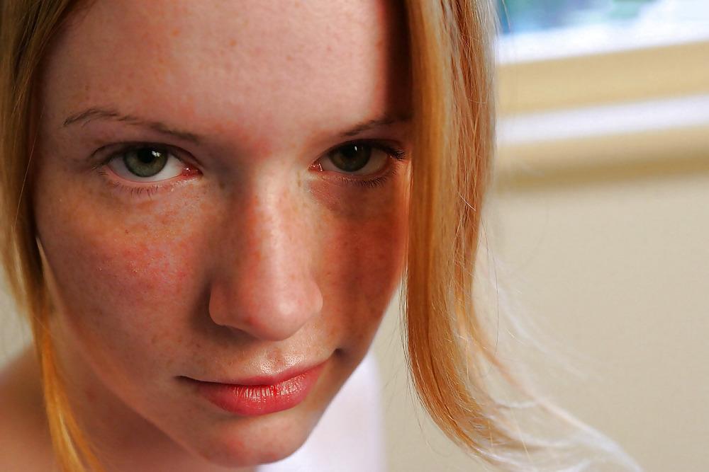 12P Lovely redhead on her bed