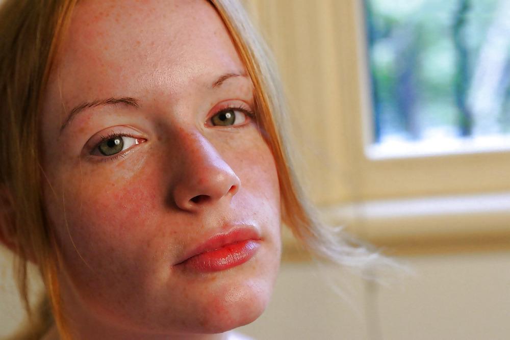 12P Lovely redhead on her bed
