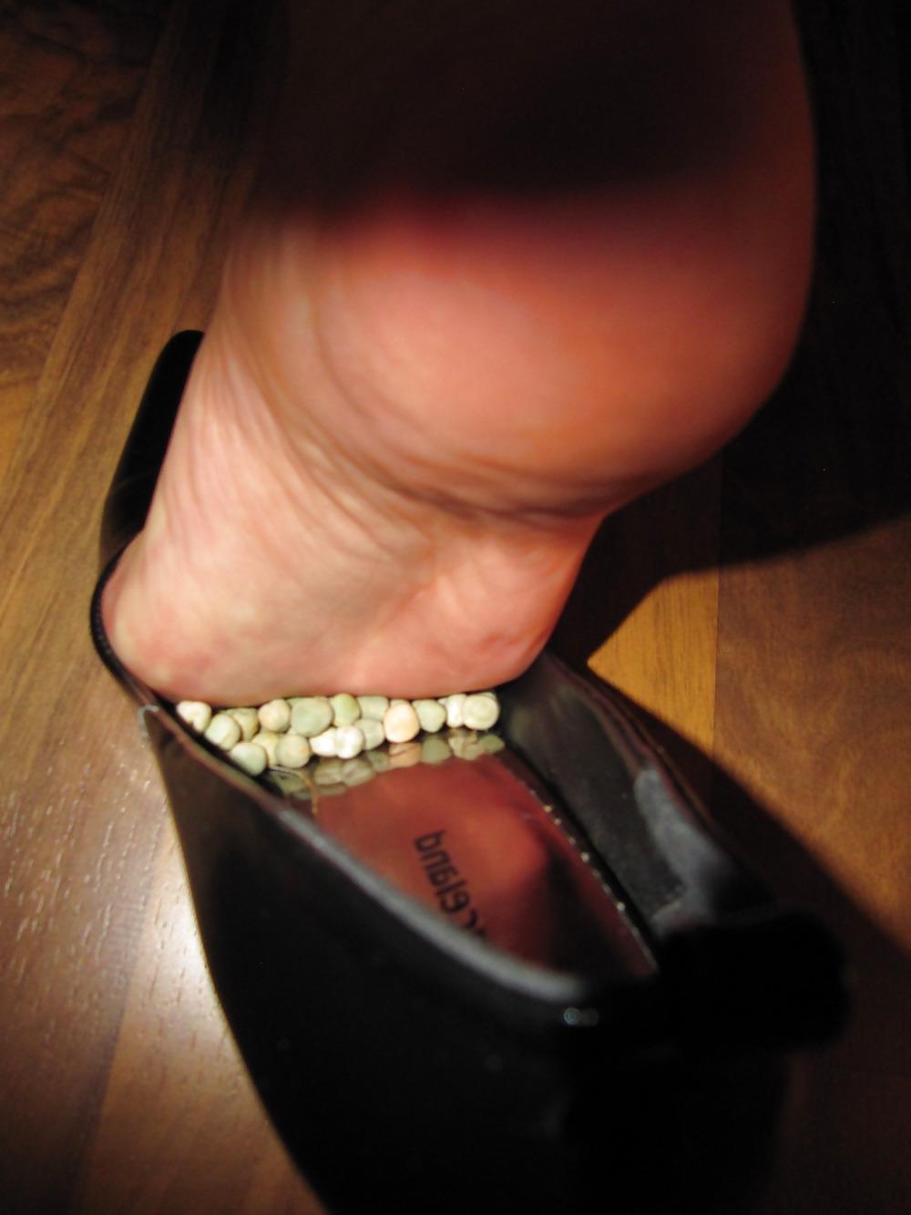 22P Foot torture with peas in high heels, leggings and corset