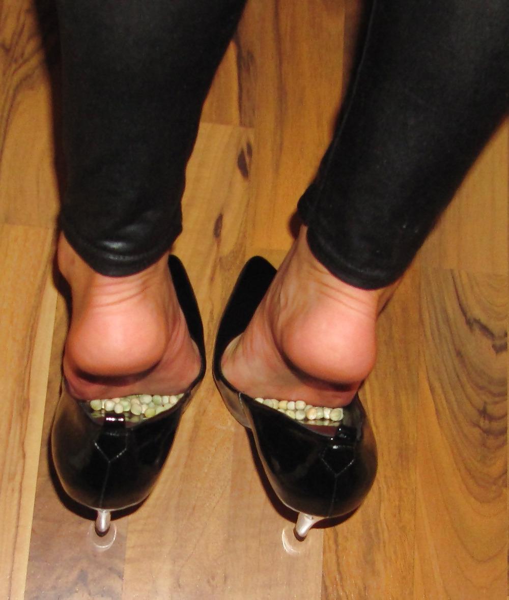 22P Foot torture with peas in high heels, leggings and corset