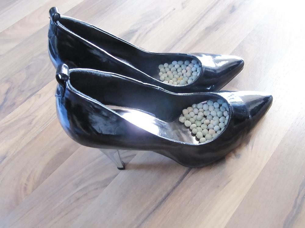 22P Foot torture with peas in high heels, leggings and corset