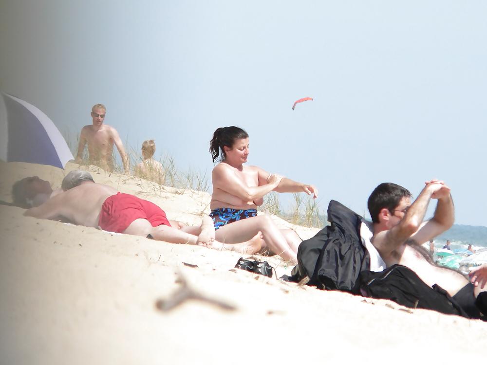 15P Chubby beach topless brunette