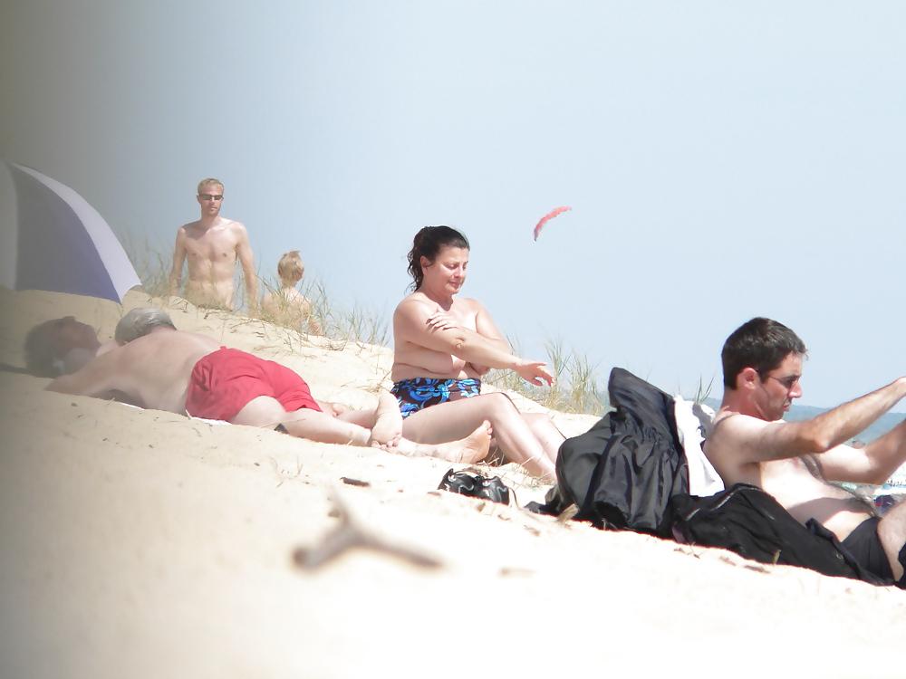 15P Chubby beach topless brunette