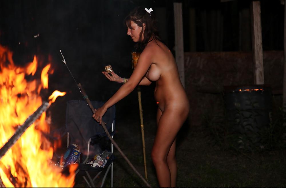 24P Nudist girl playing with fire.