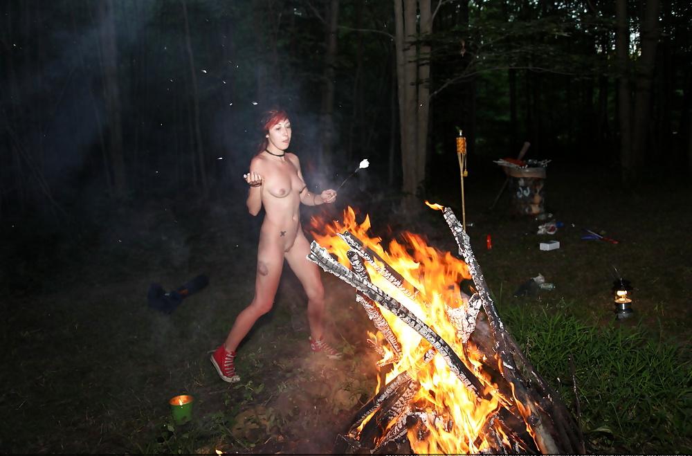 24P Nudist girl playing with fire.