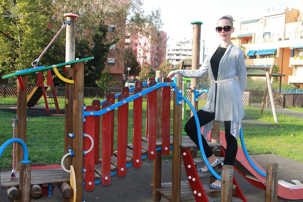 16P Lovely Christelle is showing her fine feet on a children playground