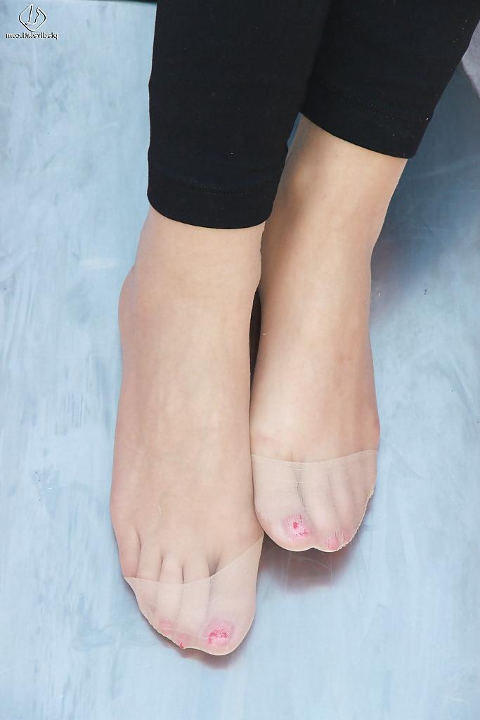 16P Lovely Christelle is showing her fine feet on a children playground