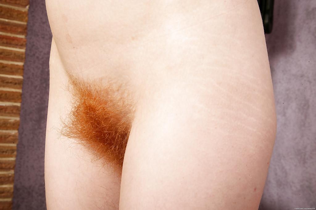 16P Sporty redhead lassie undressing and showcasing her shaggy twat