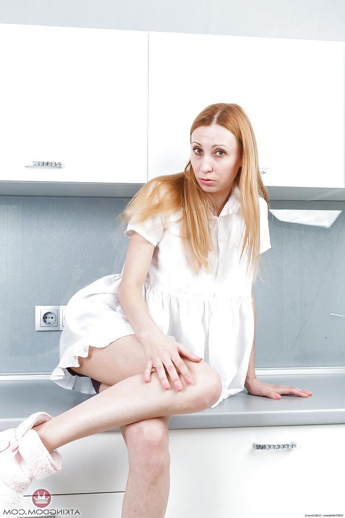 16P Older redhead model Kler undressing to reveal her hairy pussy
