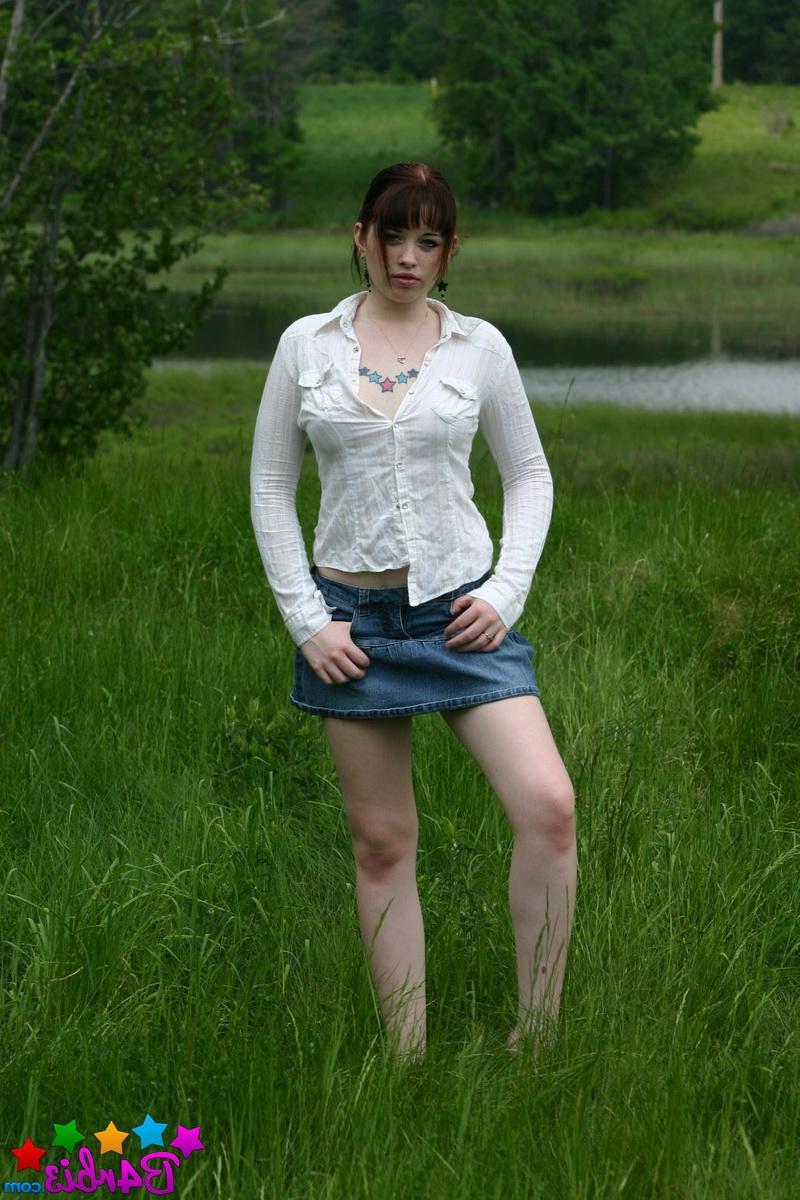12P Barbie shows off her perky boobs as she unbuttons her top outside in the grass field
