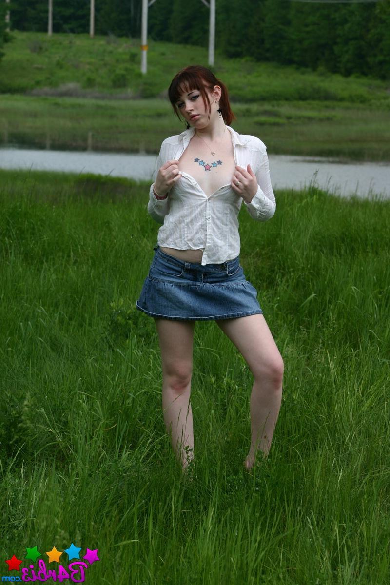 12P Barbie shows off her perky boobs as she unbuttons her top outside in the grass field