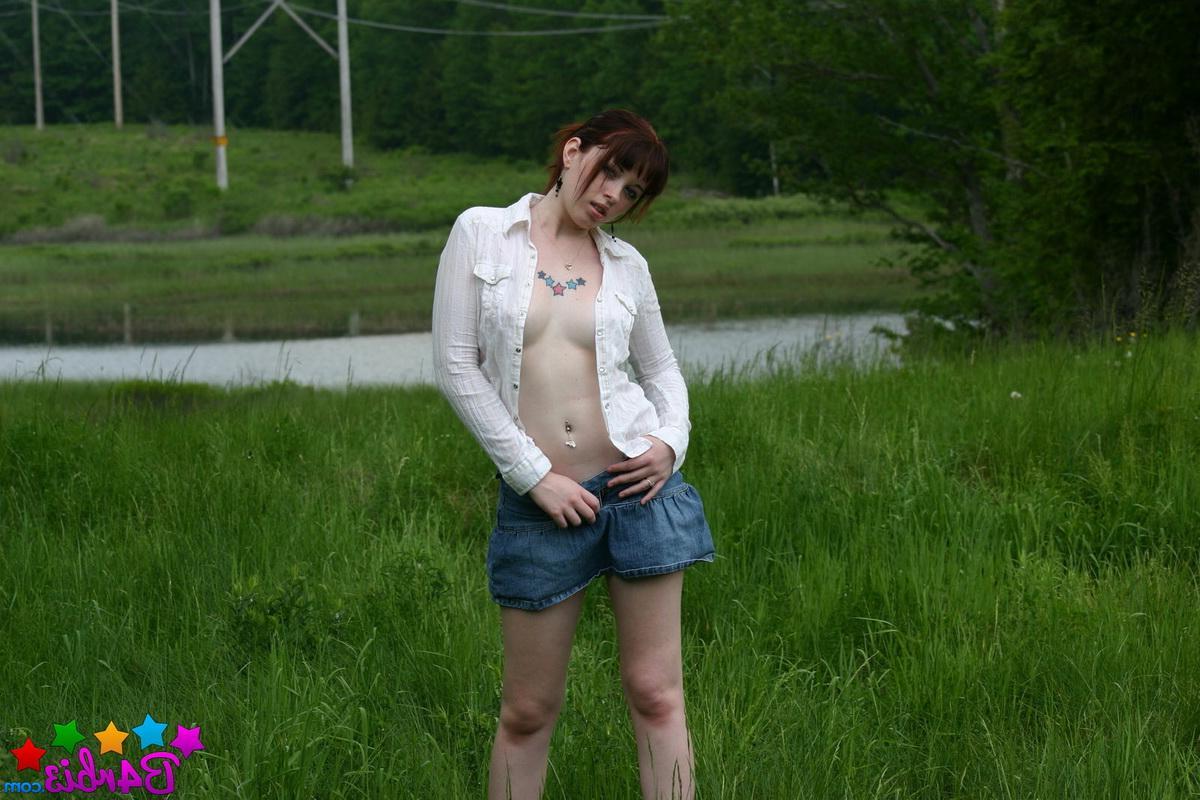 12P Barbie shows off her perky boobs as she unbuttons her top outside in the grass field