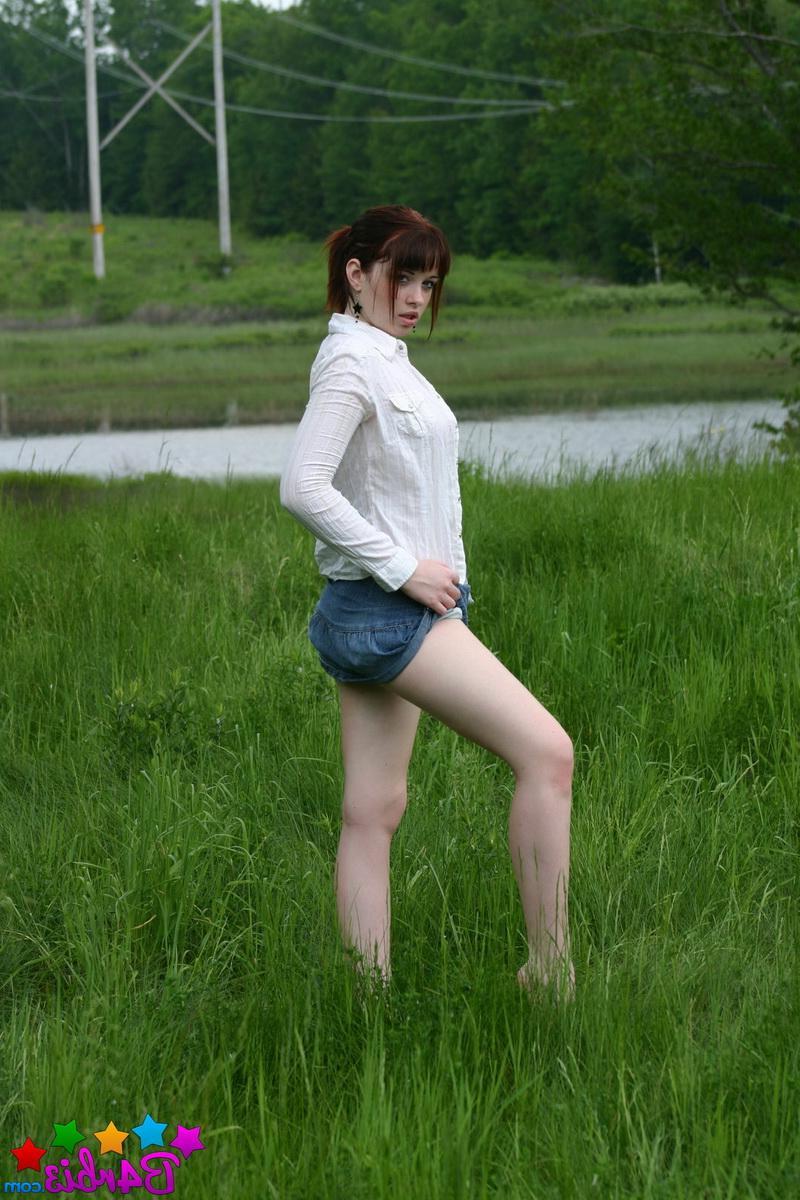 12P Barbie shows off her perky boobs as she unbuttons her top outside in the grass field