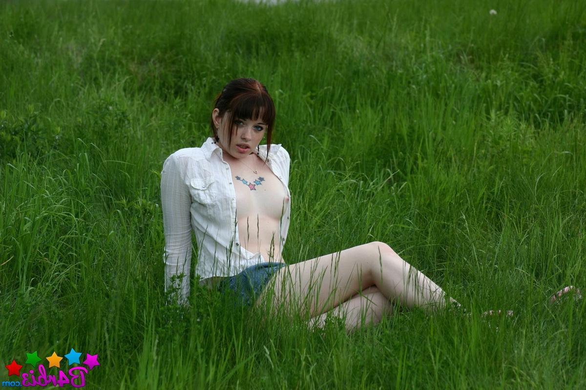 12P Barbie shows off her perky boobs as she unbuttons her top outside in the grass field