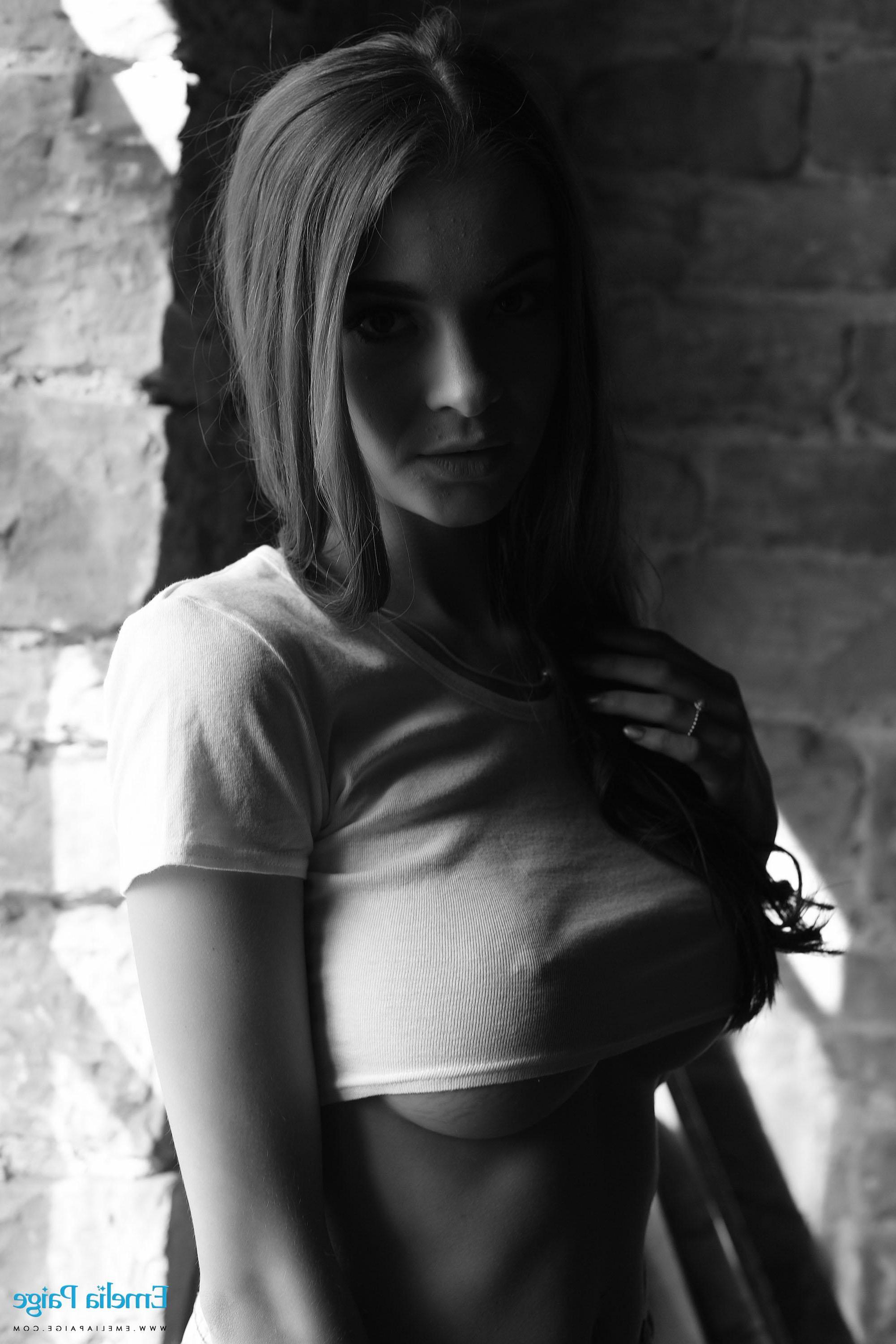 16P Emelia Paige removes her top to reveal her big boobs in black and white