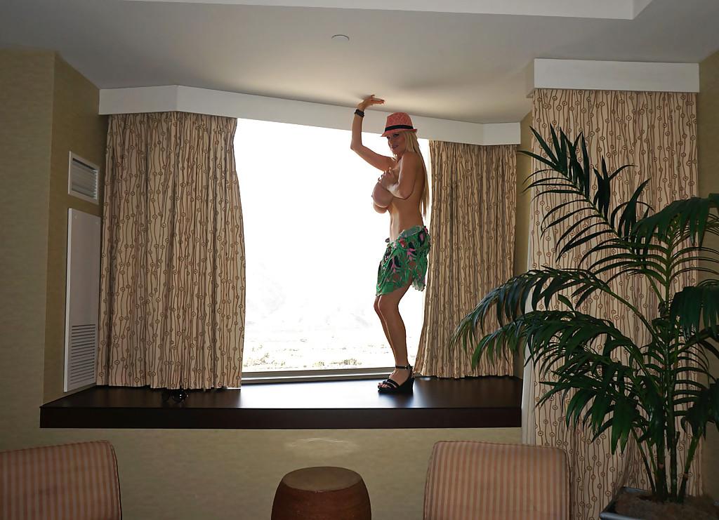 15P Top heavy blonde mom Kelly Madison masturbating in window with hat on