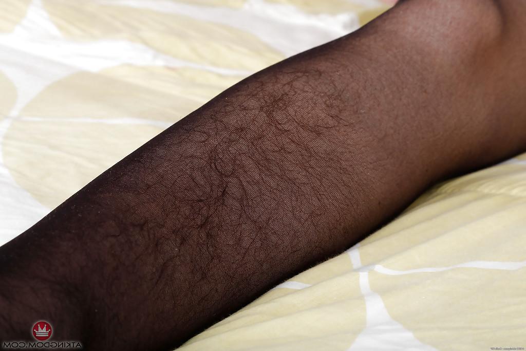 16P Hairy MILF Simone Delilah peeling off black nylons and lingerie to pose naked