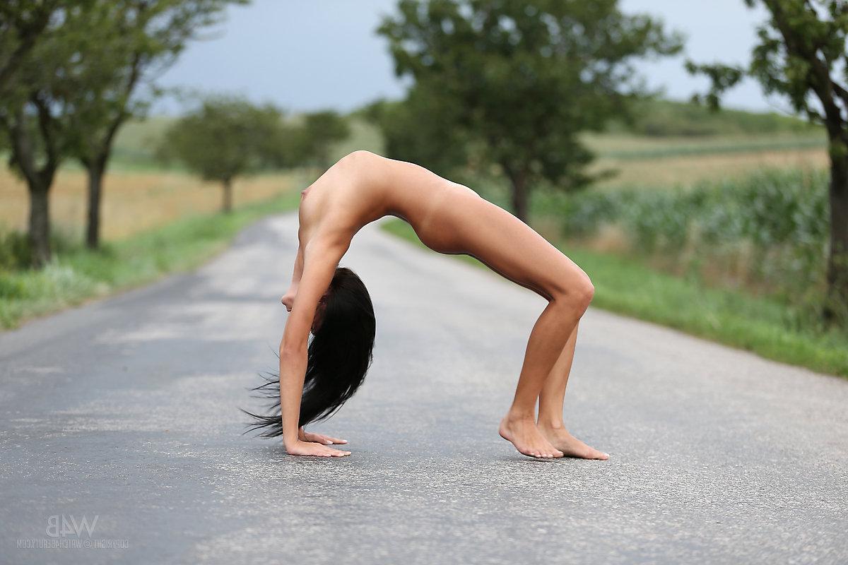 16P Beautiful brunette Mira does some nude gymnastic exercise outside