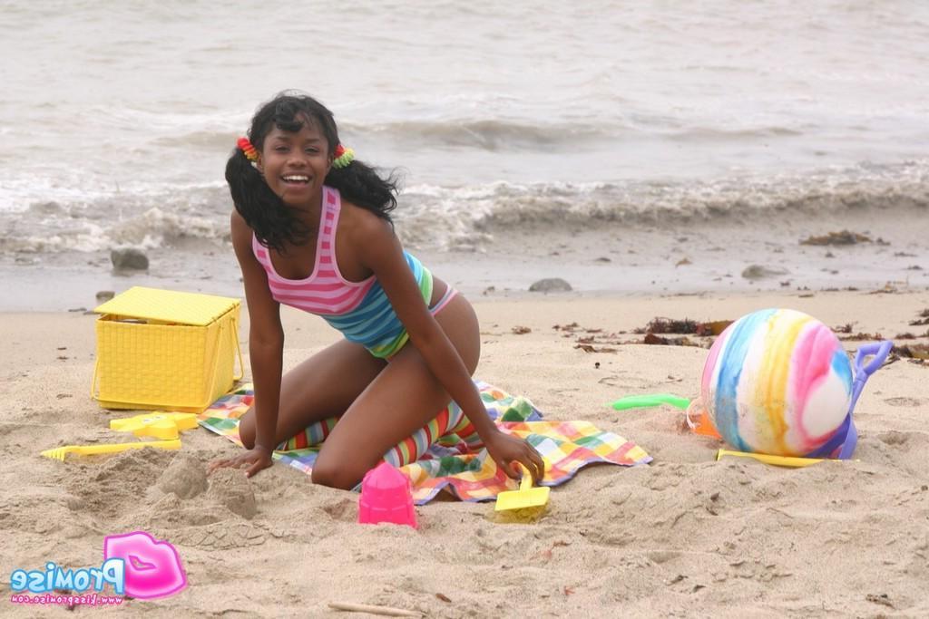 19P Pictures of ebony teen Kiss Promise flashing on a beach
